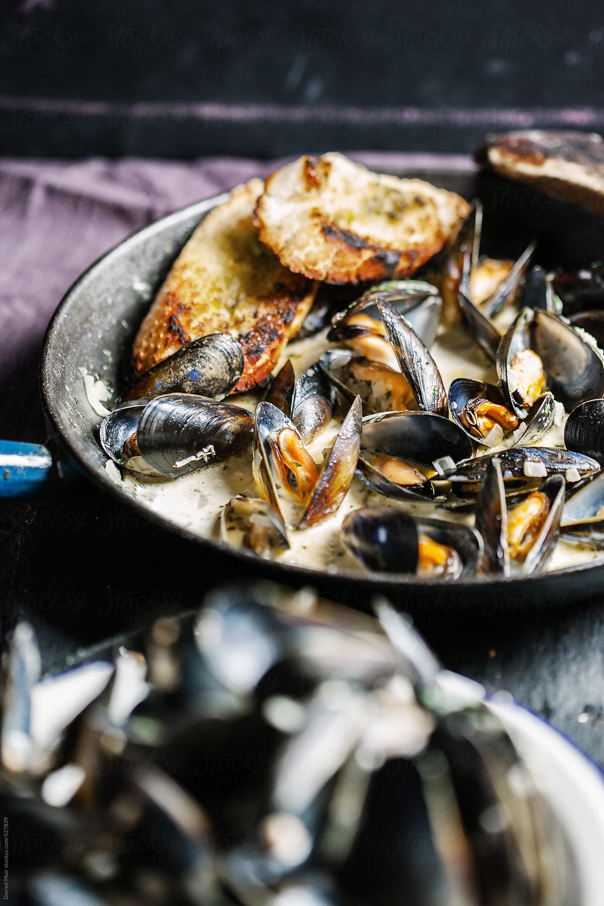 Cooked mussels in a creamy garlic and white wine sauce.