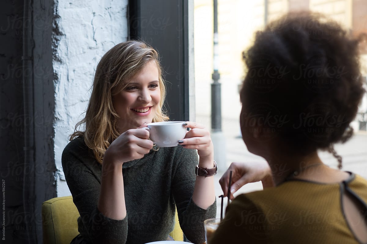 Smiling Caucasian Woman Having Coffee With A Friend