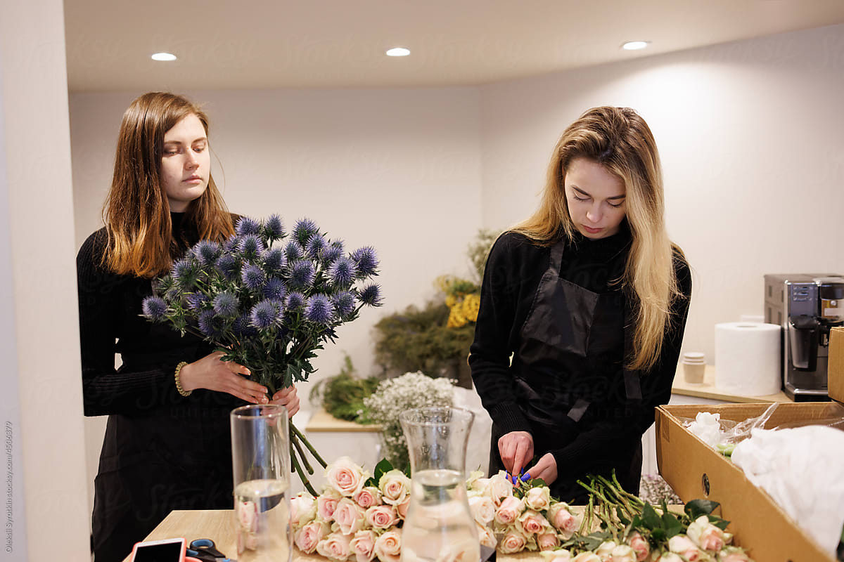 Flower dealers designing bouquets in floral studio