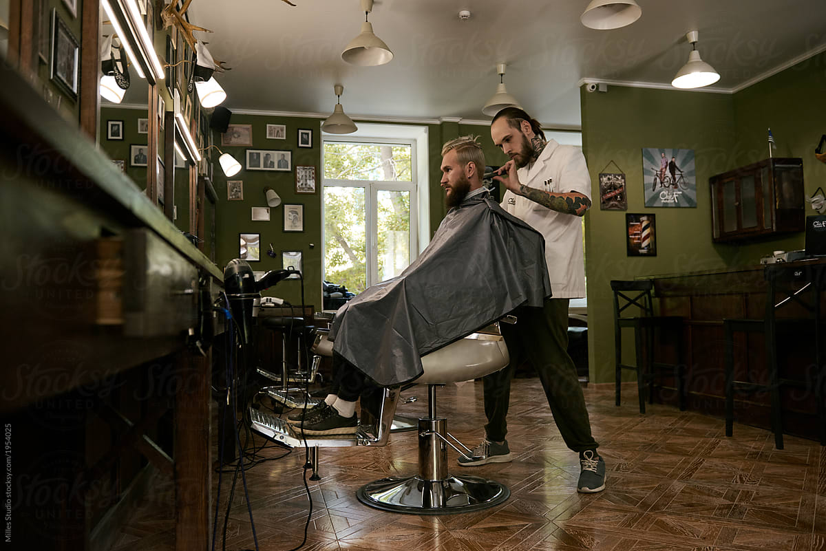 Barber giving haircut in salon