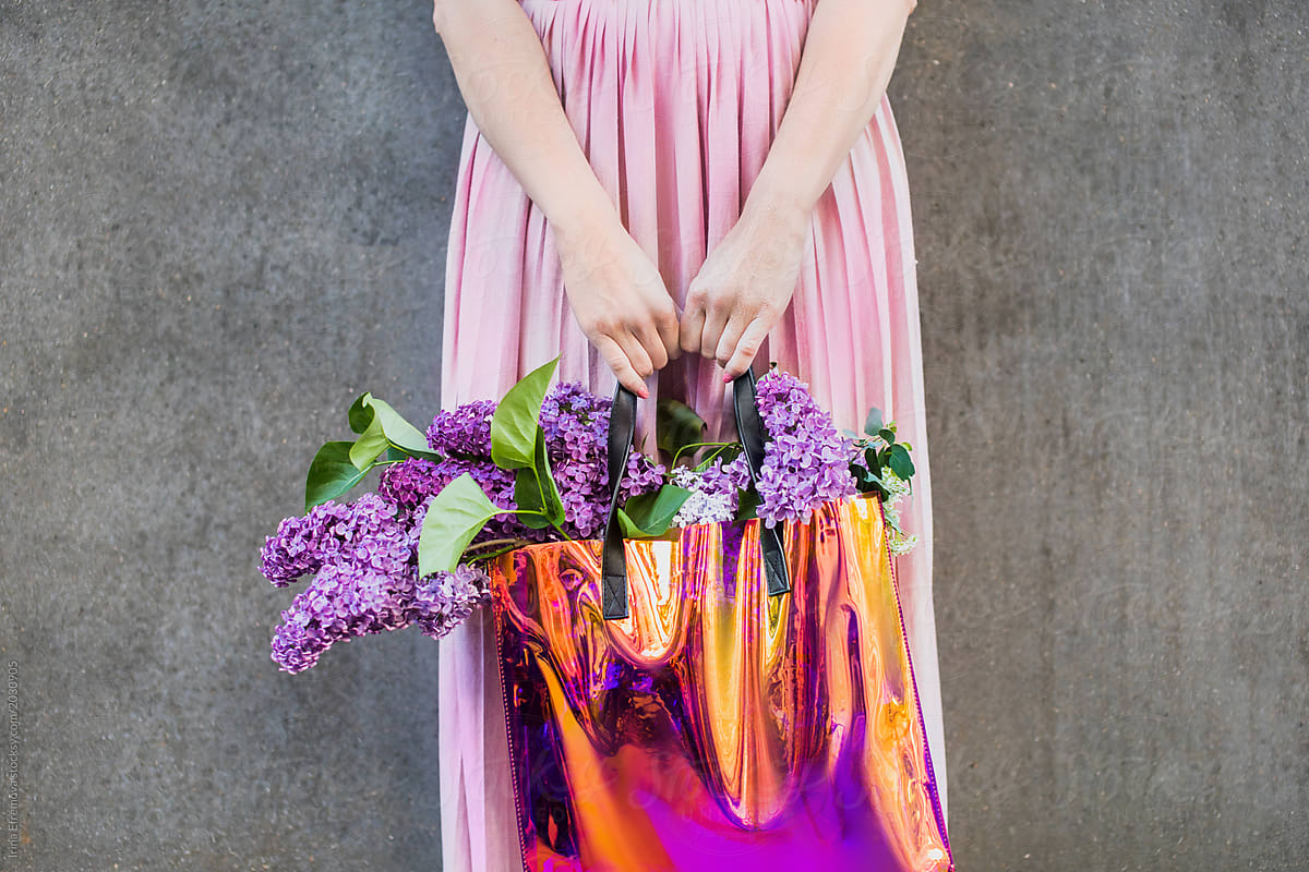 Woman holding a bag of flowers