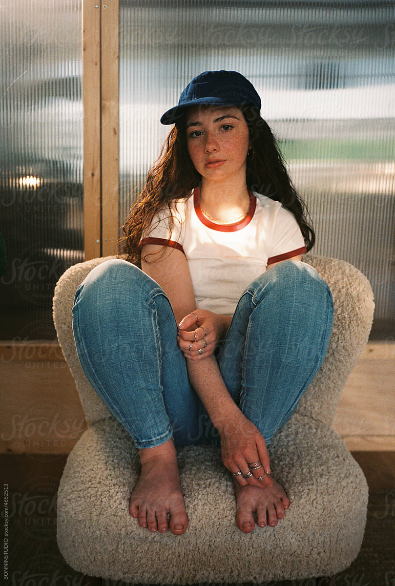 User-generated content freckled teen girl resting on armchair