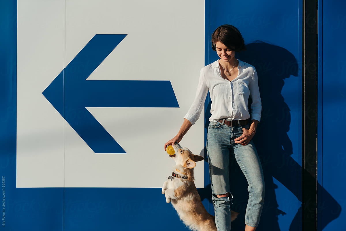A woman with a dog in the city.
