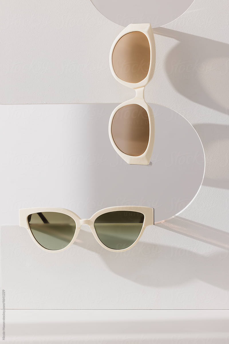 two pairs of sunglasses hanging on architectural shape