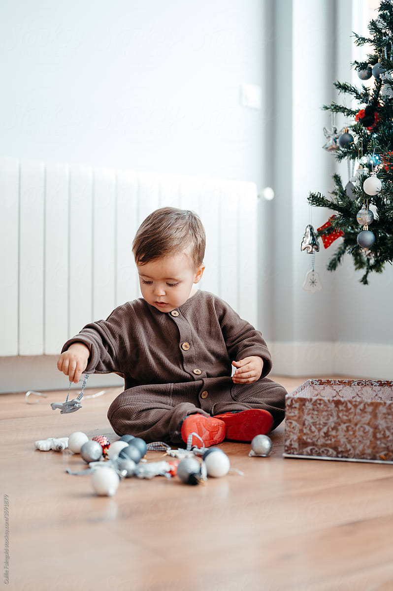 Toddler playing with Christmas decorations