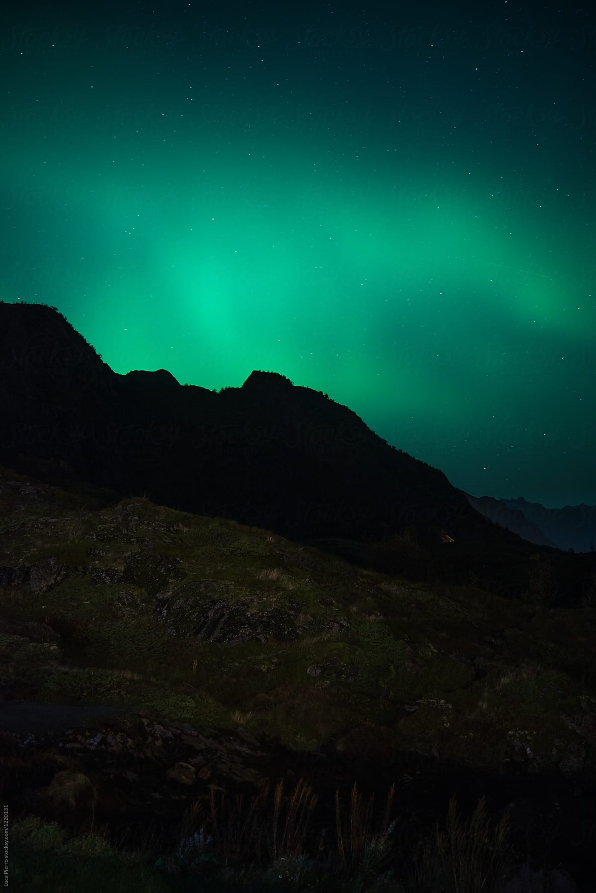 Northern lights behind mountains