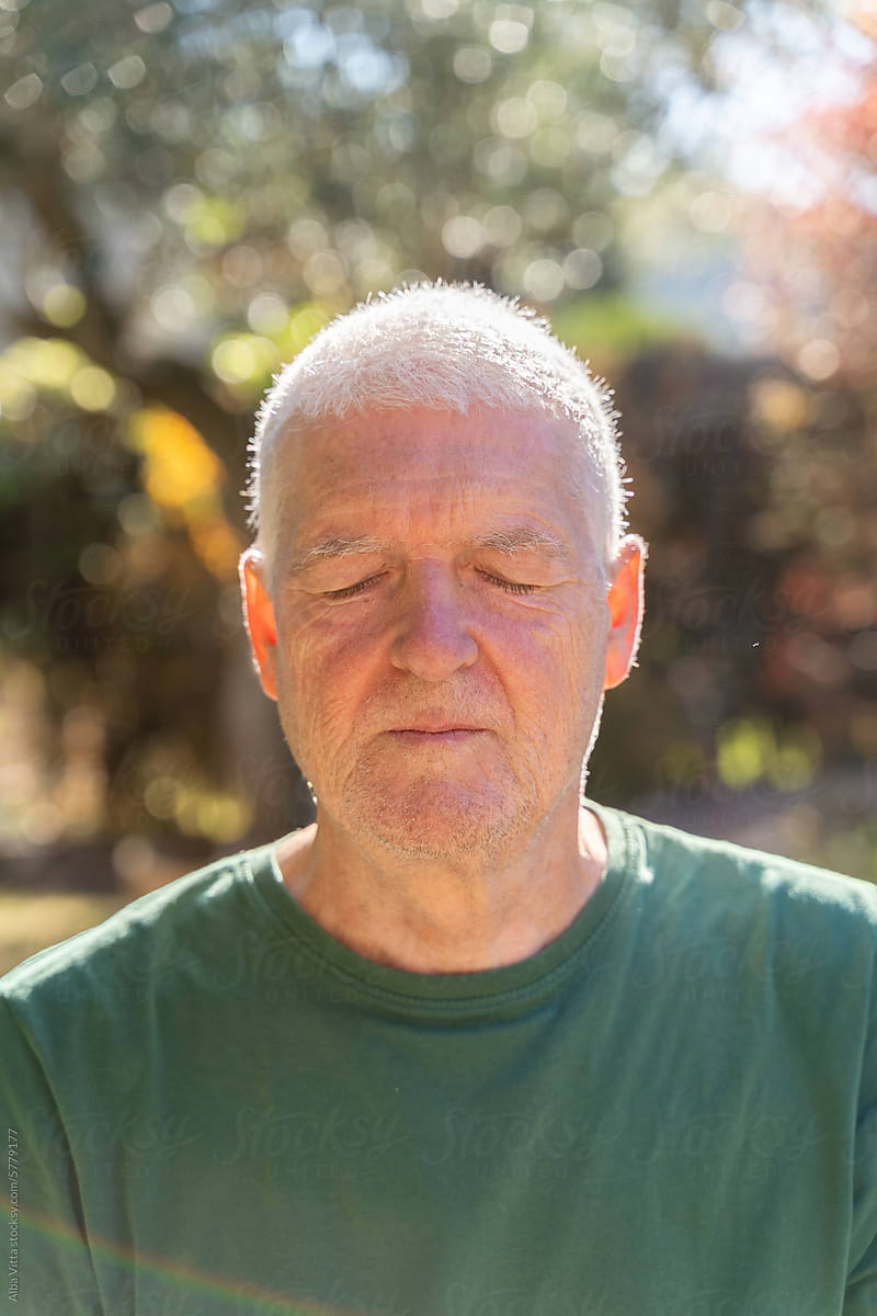 Closed eyes senior man portrait