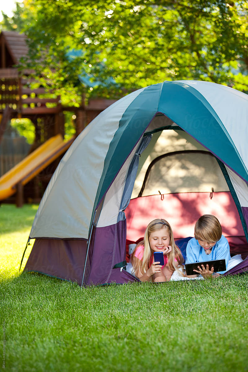 Camping: Kids in Tent with Phone and Computer Instead of Playing