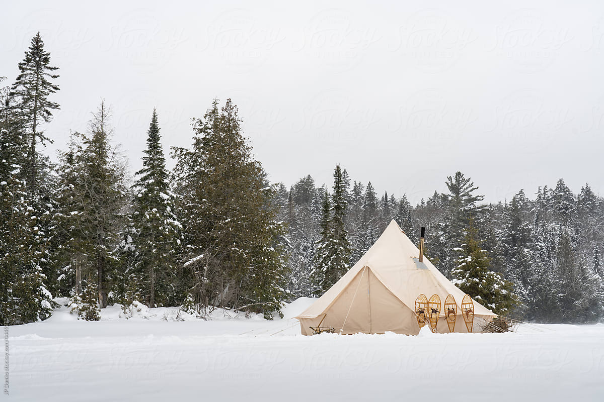 Traditional Tent Campsite with Snowshoes in Winter Landscape