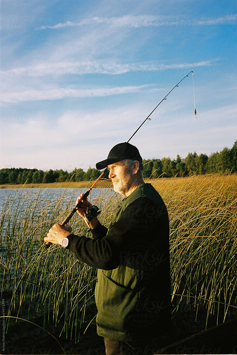 Film photo of a man fishing on a lake