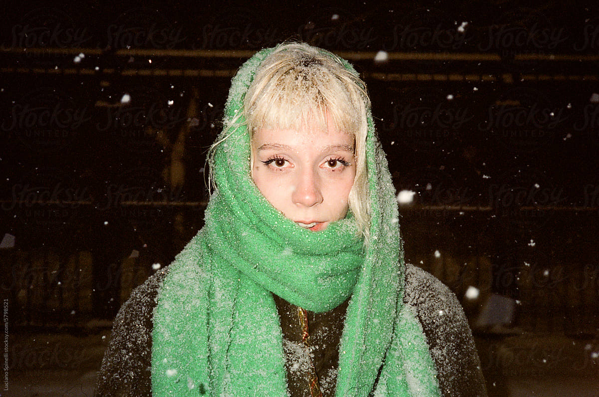 Portrait of a Z generation blond girl with a green scarf over her head