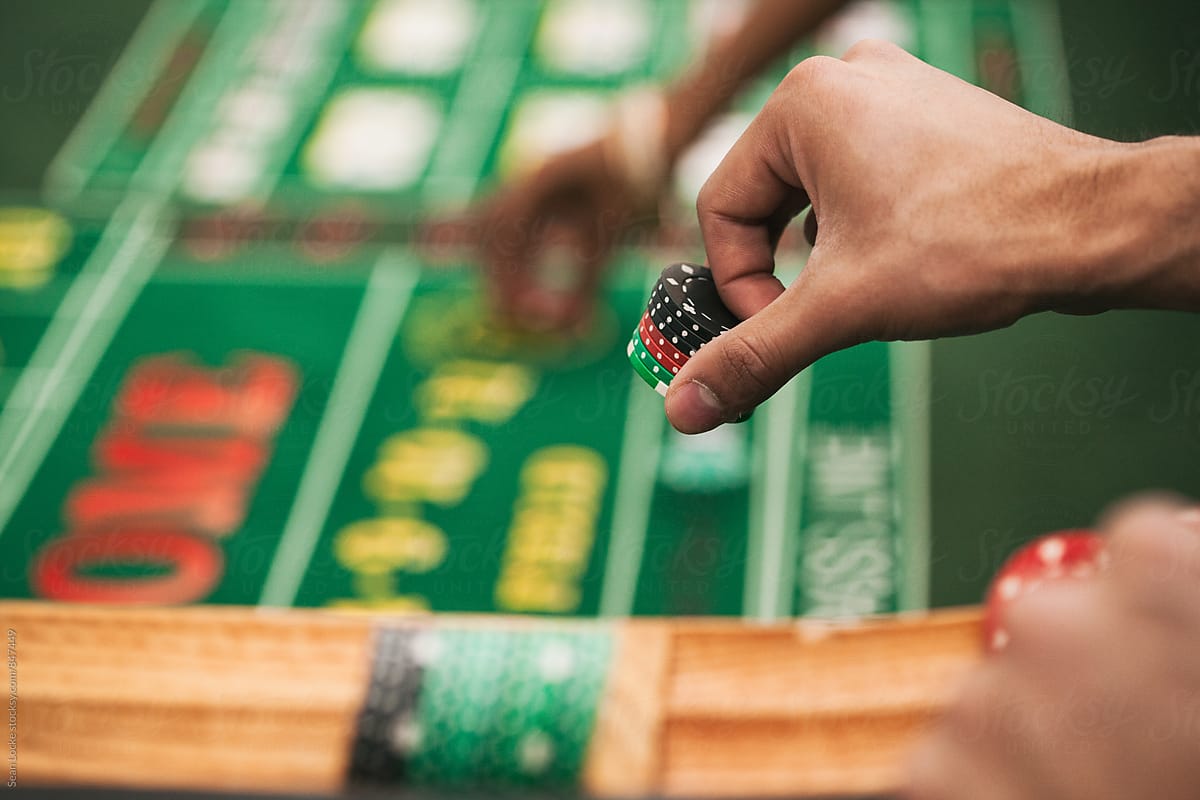 Casino: Man Placing Bet In Game Of Craps