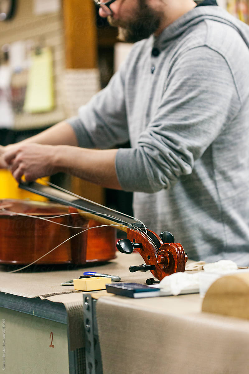 Band: Man Repairing Cello In Shop
