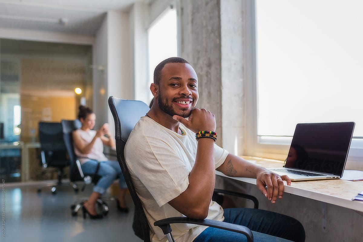 Black man at the office smiling at camera