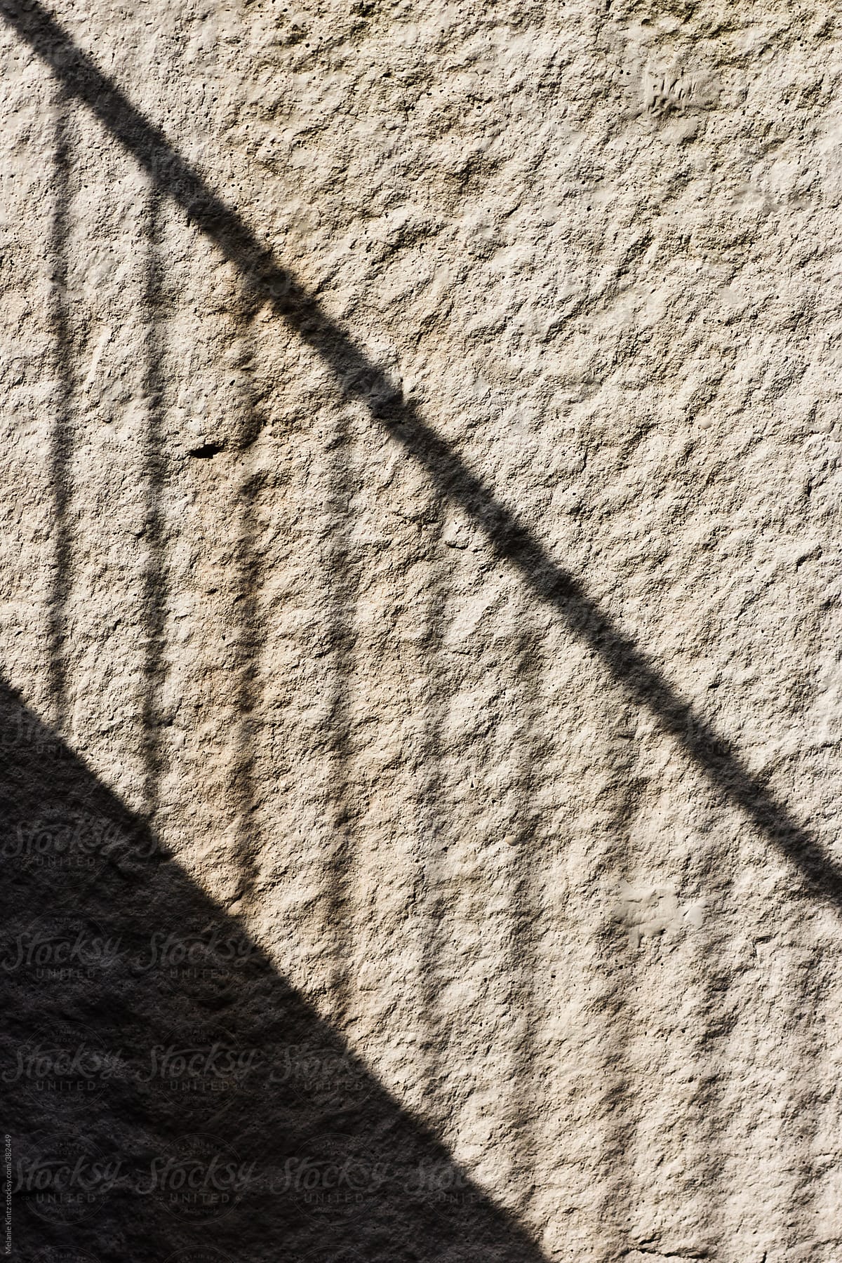 Shadow of a railing on a wall