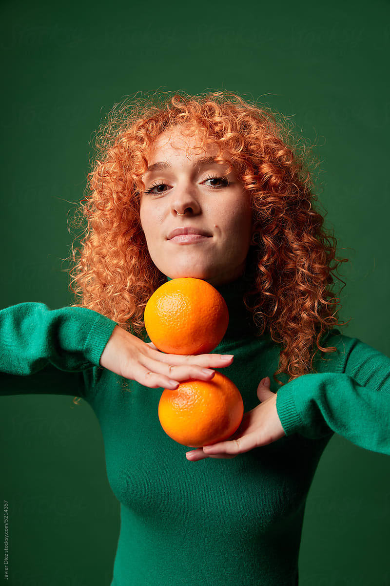 Red haired woman with oranges