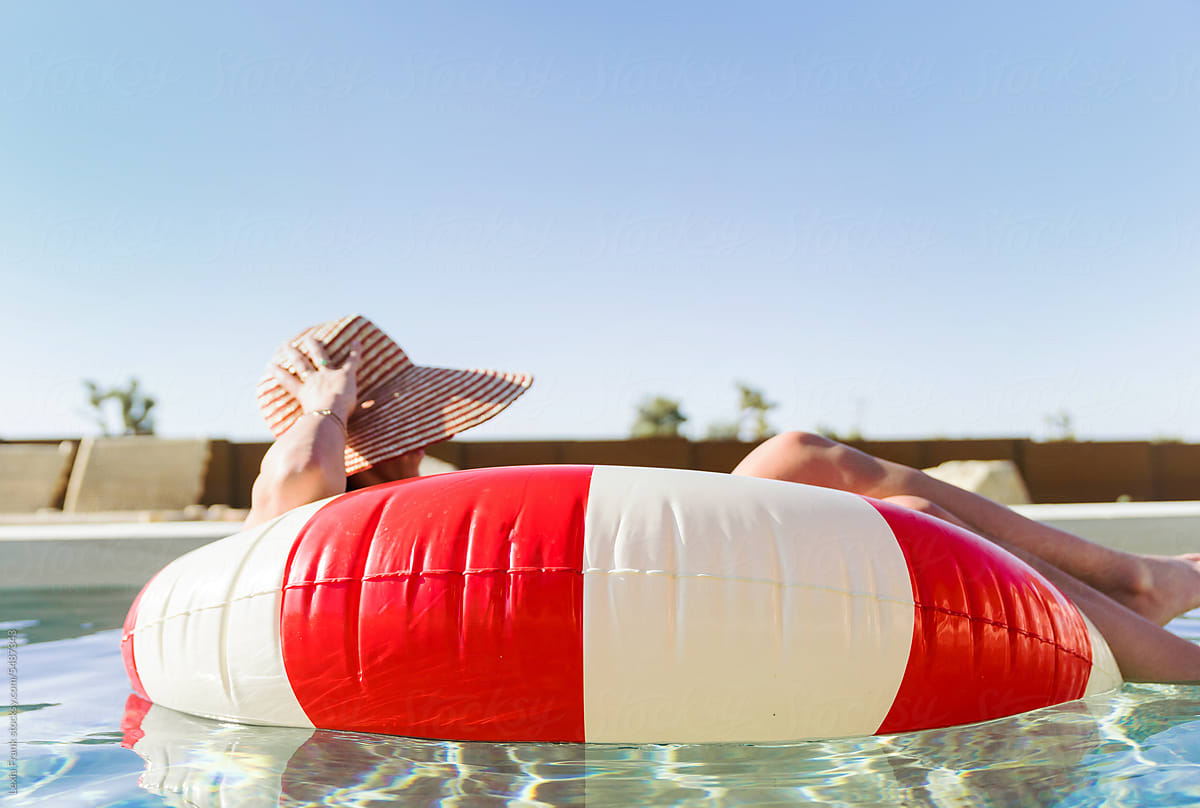 Giant Red And White Pool Floaty by Stocksy Contributor Lexia