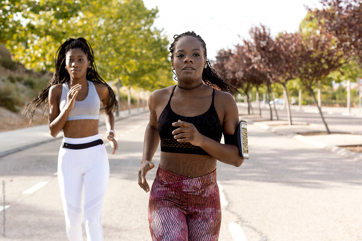 Two women friends running outdoors