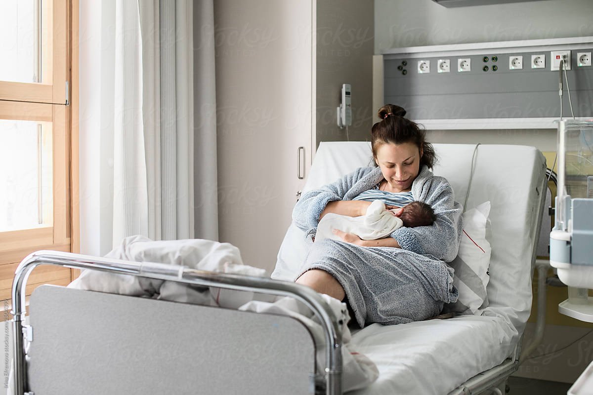 Mother And Newborn On A Hospital Bed By Stocksy Contributor Irina