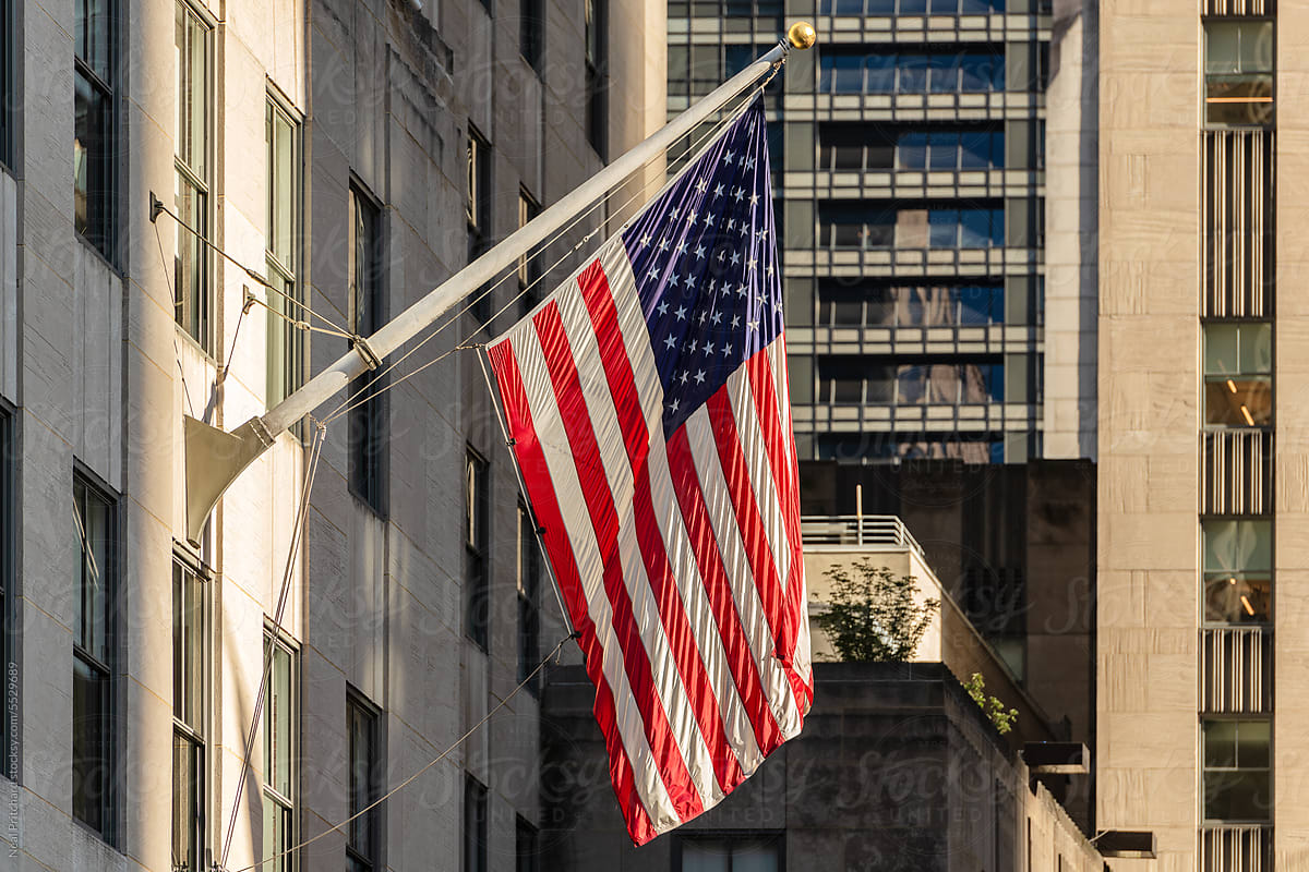 American flag hanging outside hi rise building