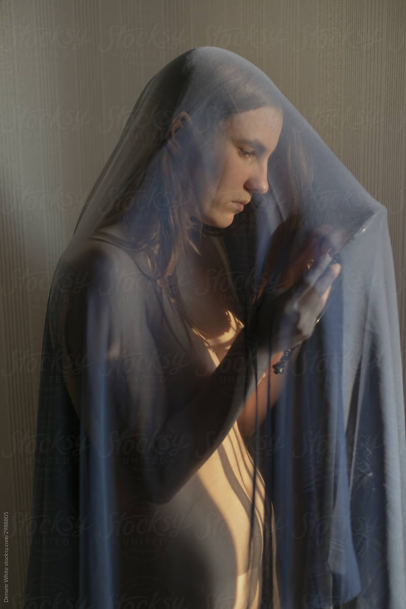 girl looks in the mirror under the veil