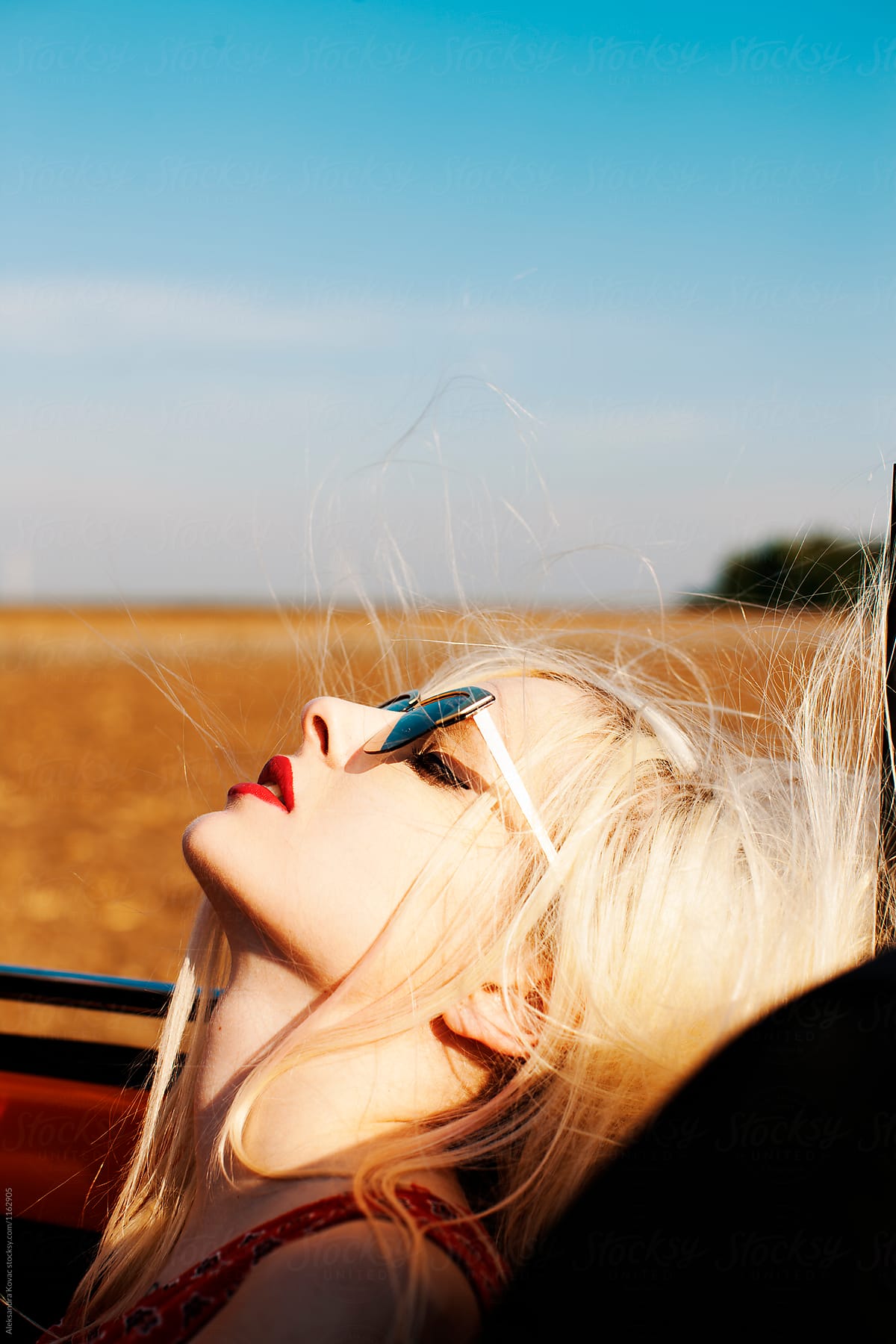 Portrait Of Sexy Blond Women Enjoys The Wind In The Car By Stocksy Contributor Alexandra 