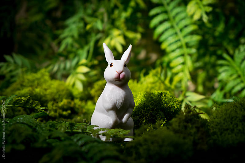 A white plastic bunny rabbit in the forest