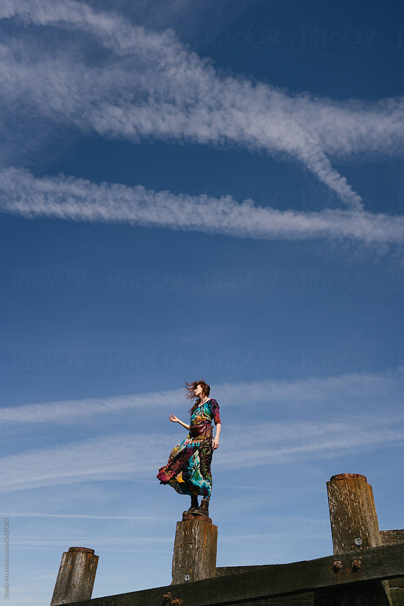 Young woman against blue sky