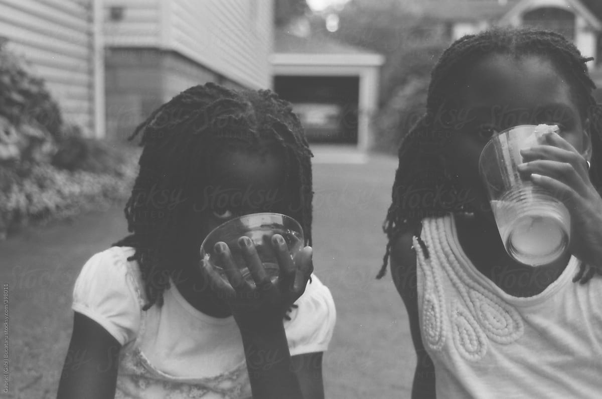 Pair of African American girls drinking lemonade