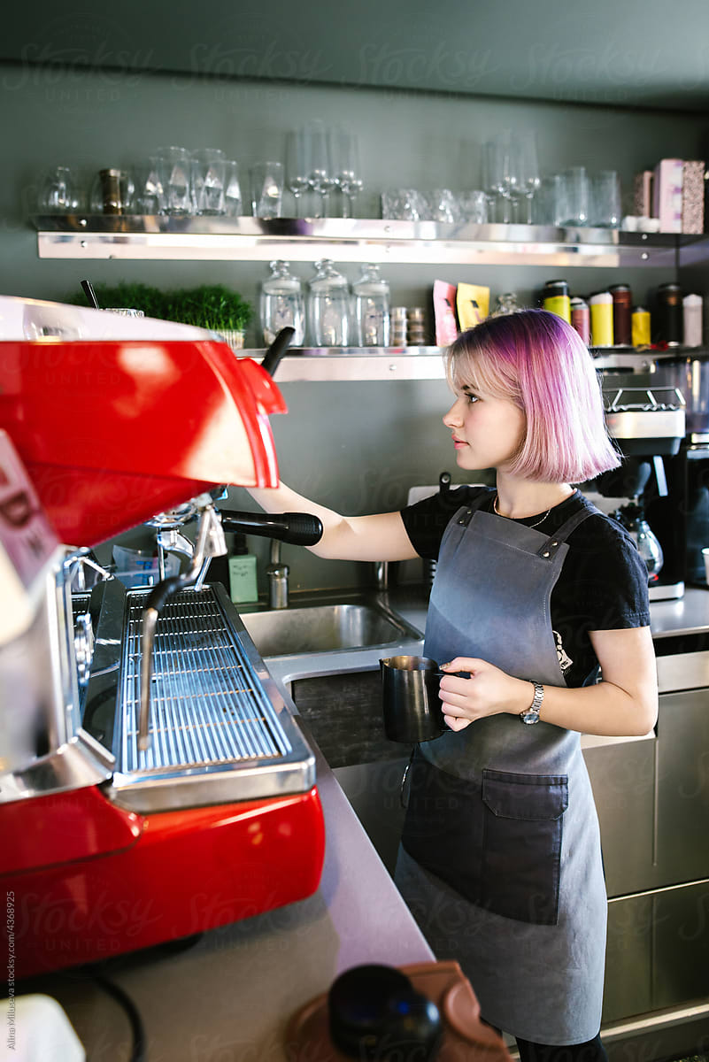 Young barista working in coffeehouse
