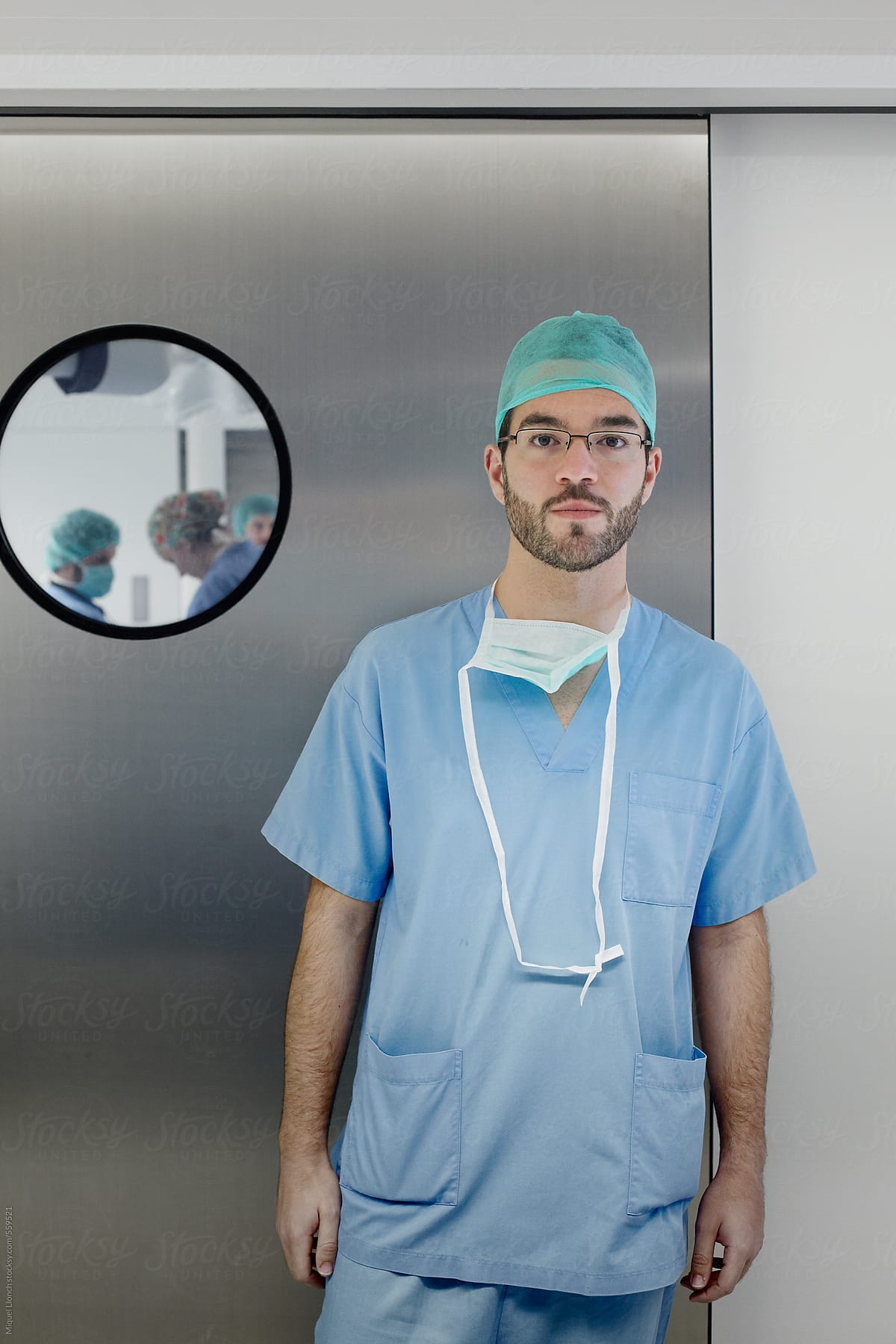 Portrait of a surgeon in front of the door of the operating room