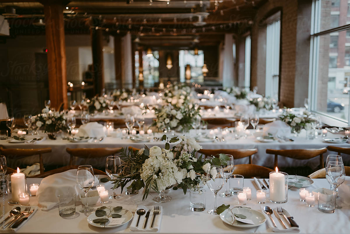 Long tables set up for wedding reception inside old building