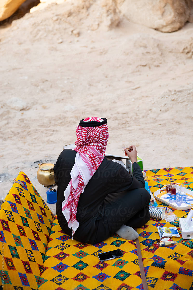Young Saudi drinking tea in the desert