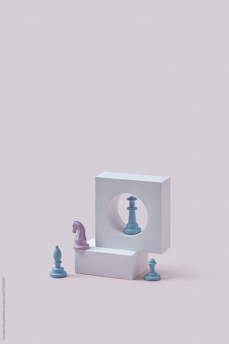 Pink and blue chess pieces with stone props.