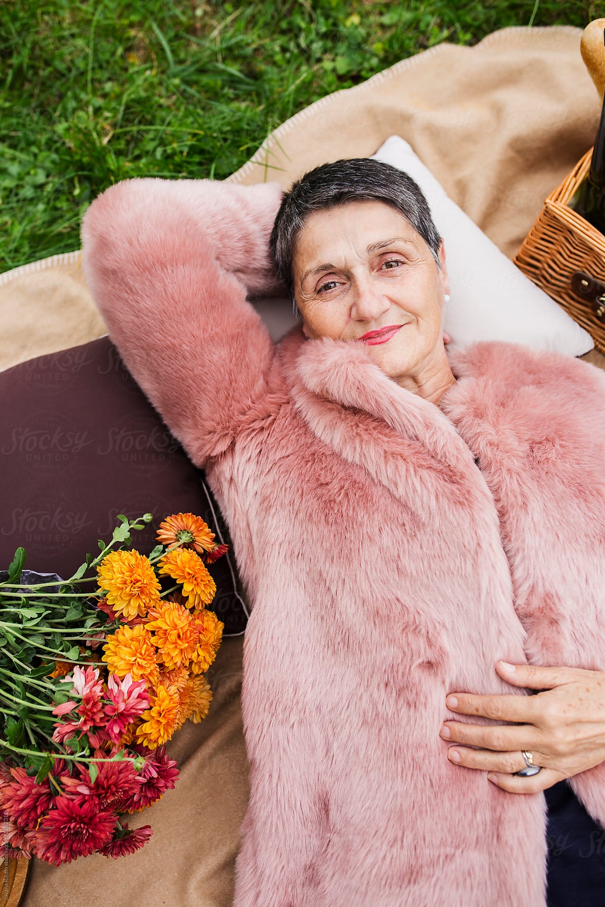 Portrait Of A Beautiful Elderly Woman Lying On Grass Del Colaborador De Stocksy Jovana Rikalo