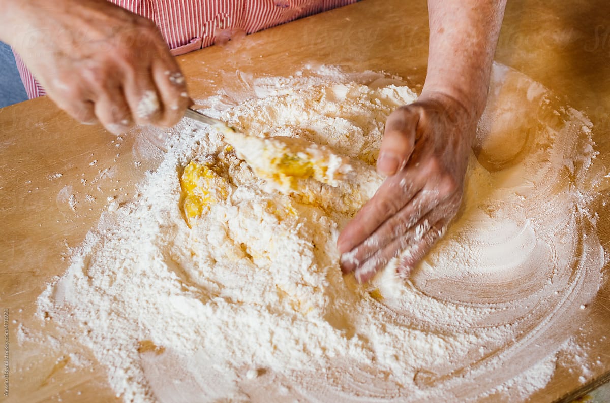 Italian woman mix flour well for pasta