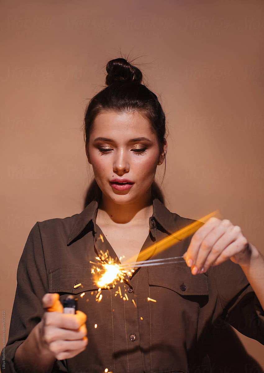Young female igniting sparklers