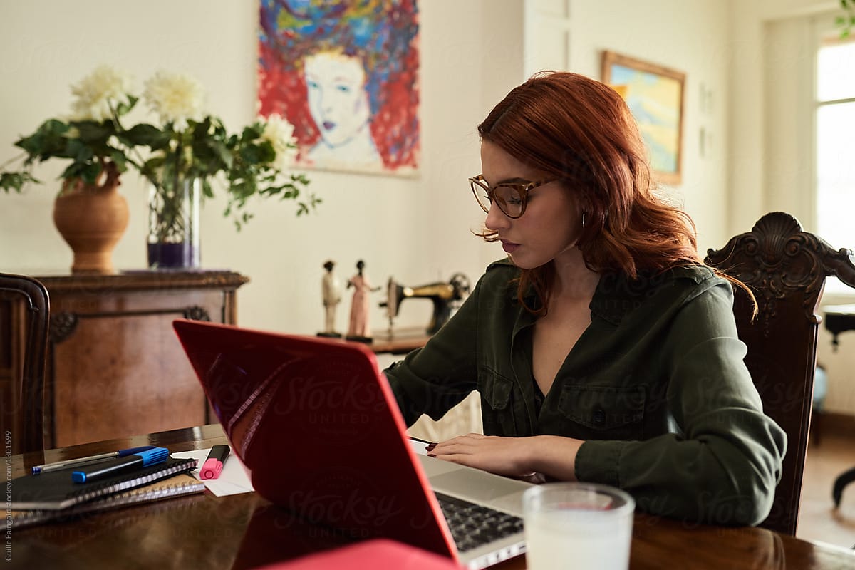 Beautiful red-haired woman in study.