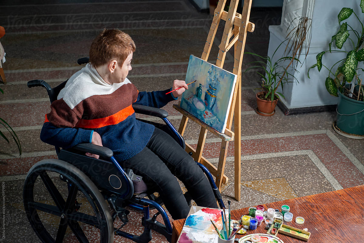 Artist in a wheelchair paints a picture