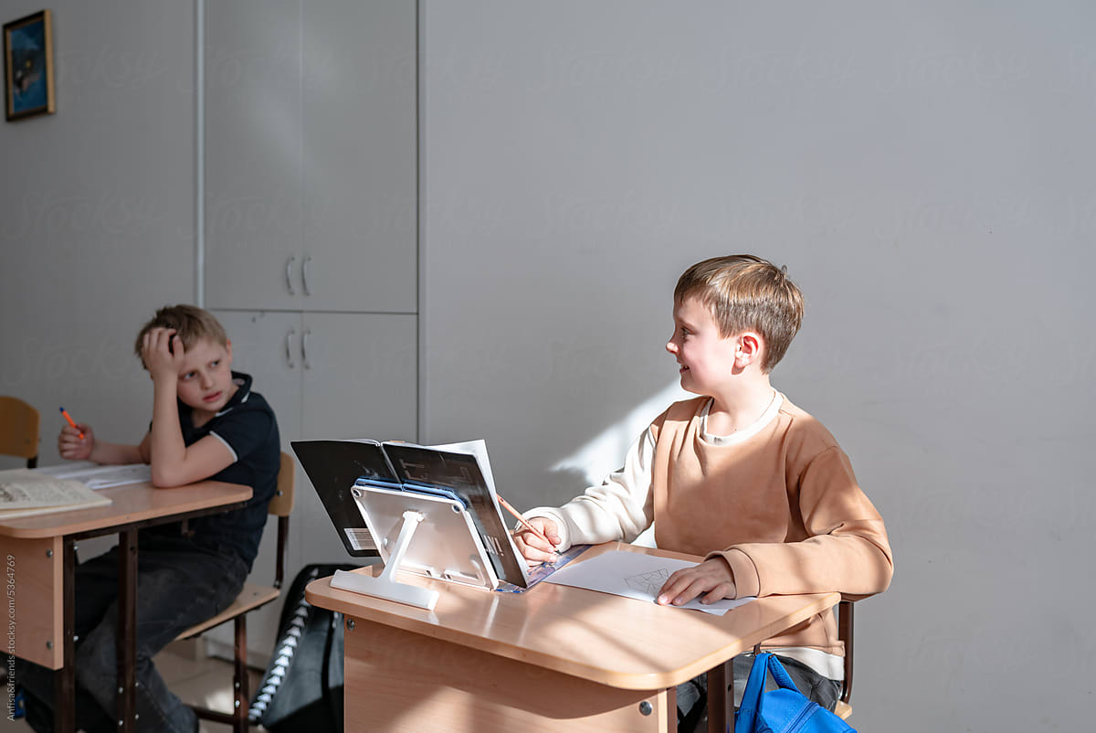 new student in a classroom sitting at a desk