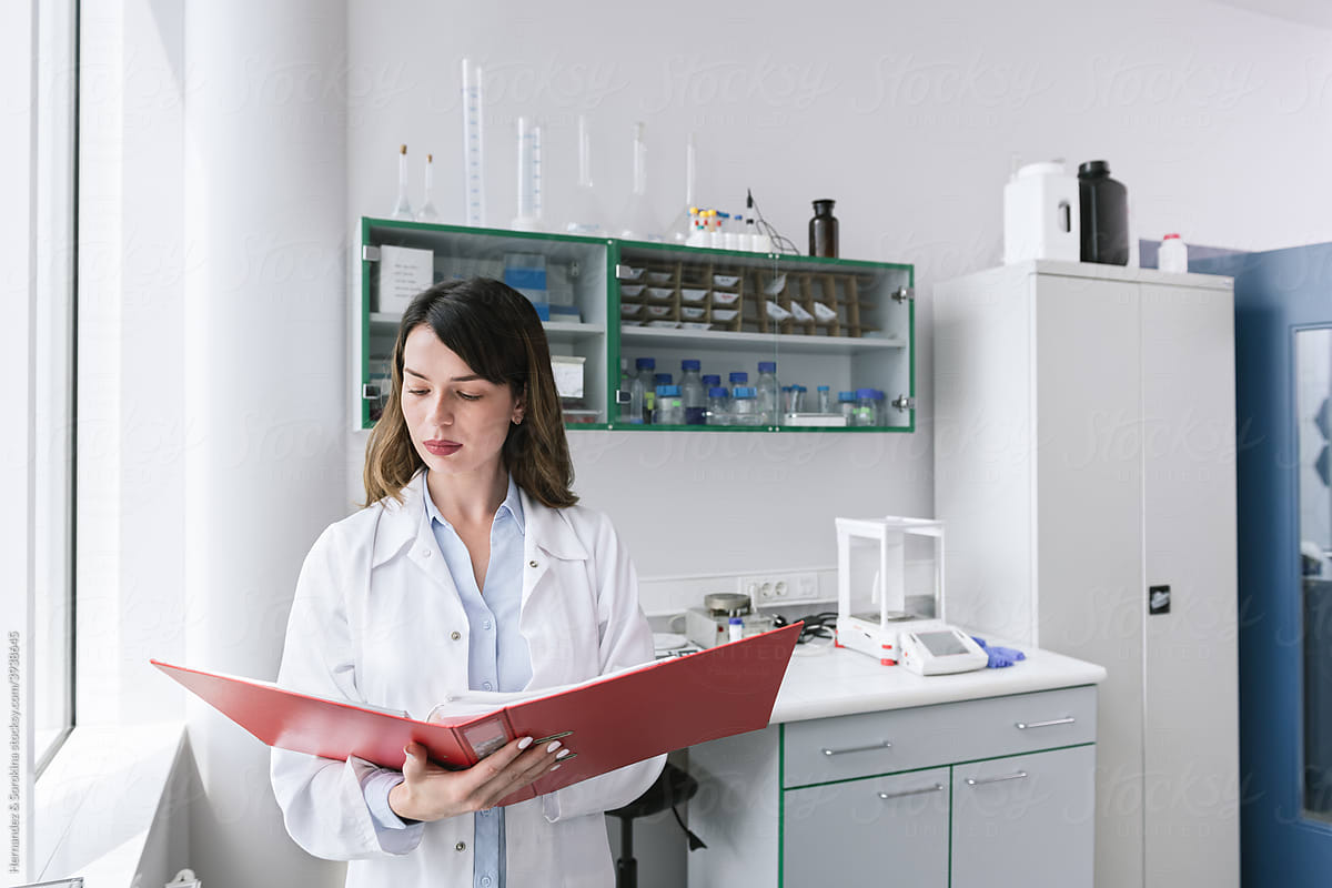 Scientist Analysing Papers In The Lab