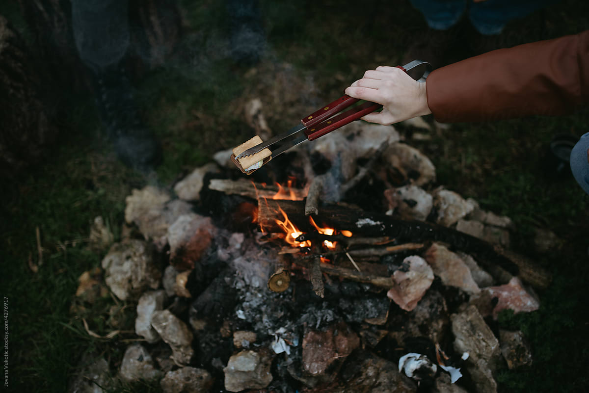 Woman sitting around campfire