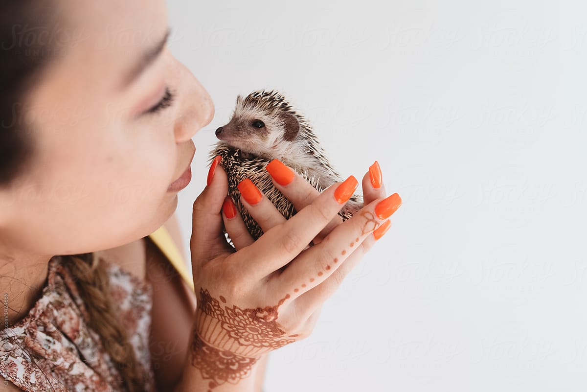 A young woman bringing her new pet hedgehog home