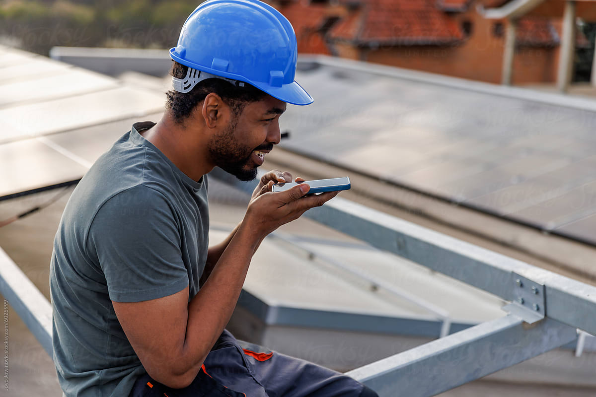 Technician using smart phone at solar power plant