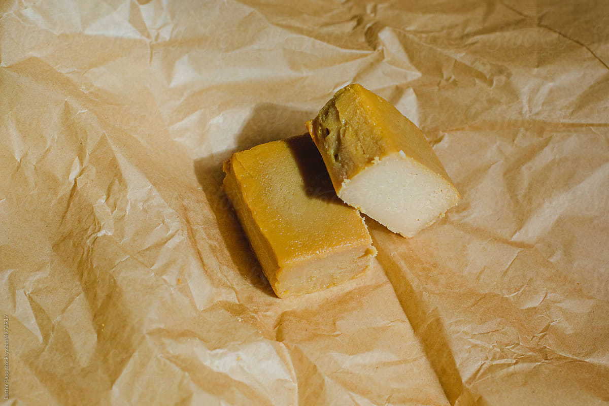 Vegan, artisan cheese in paper wrap.