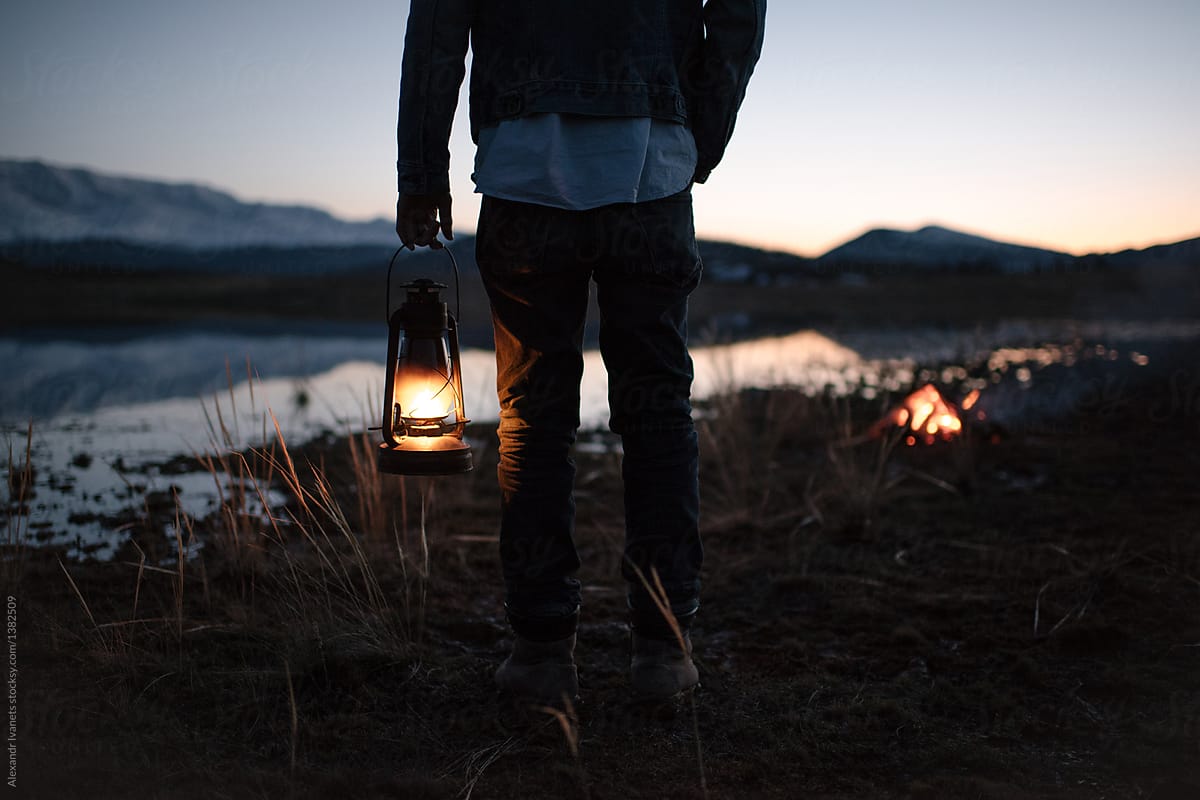 Hiker standing with lantern