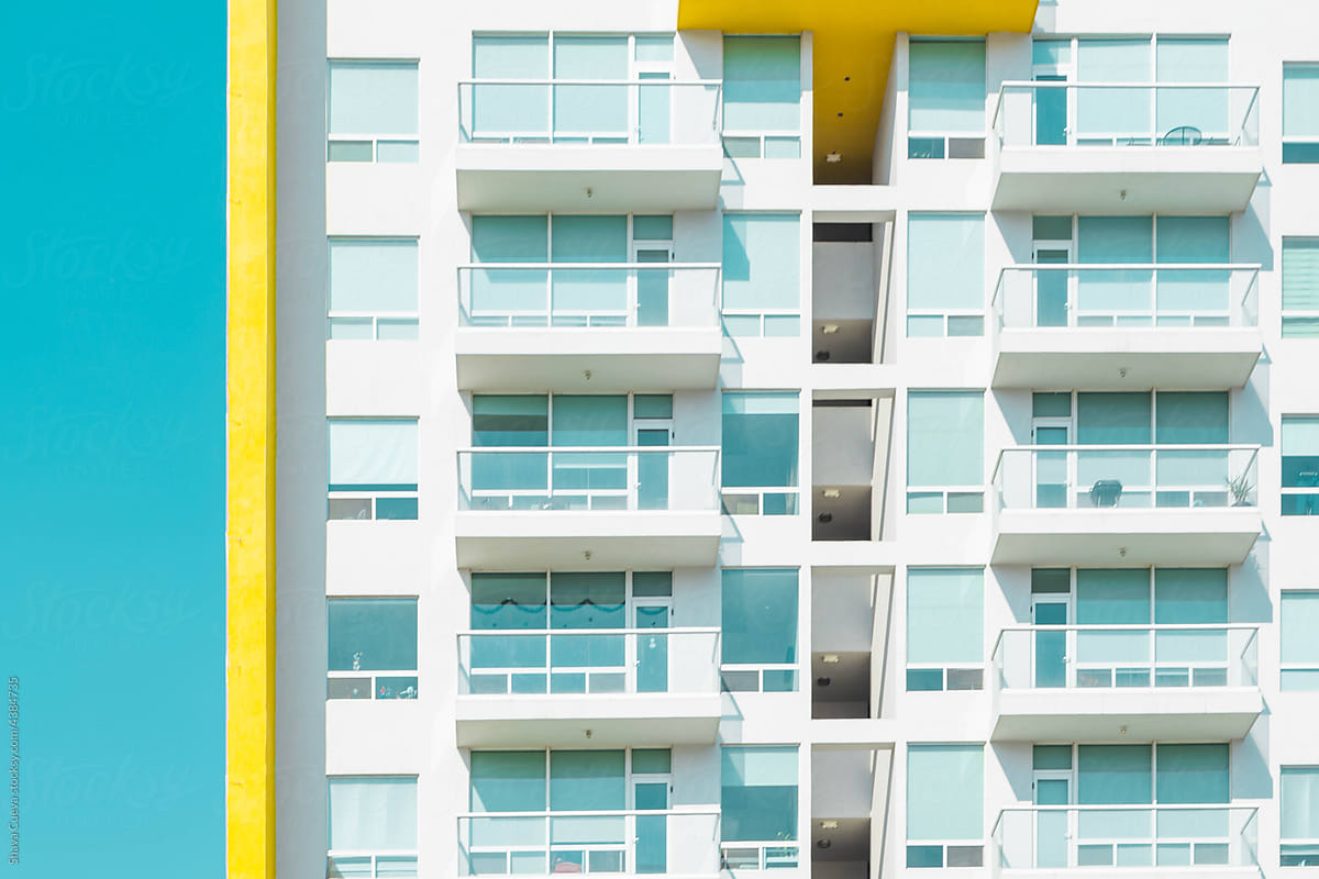 White building with crystal balconies and yellow line