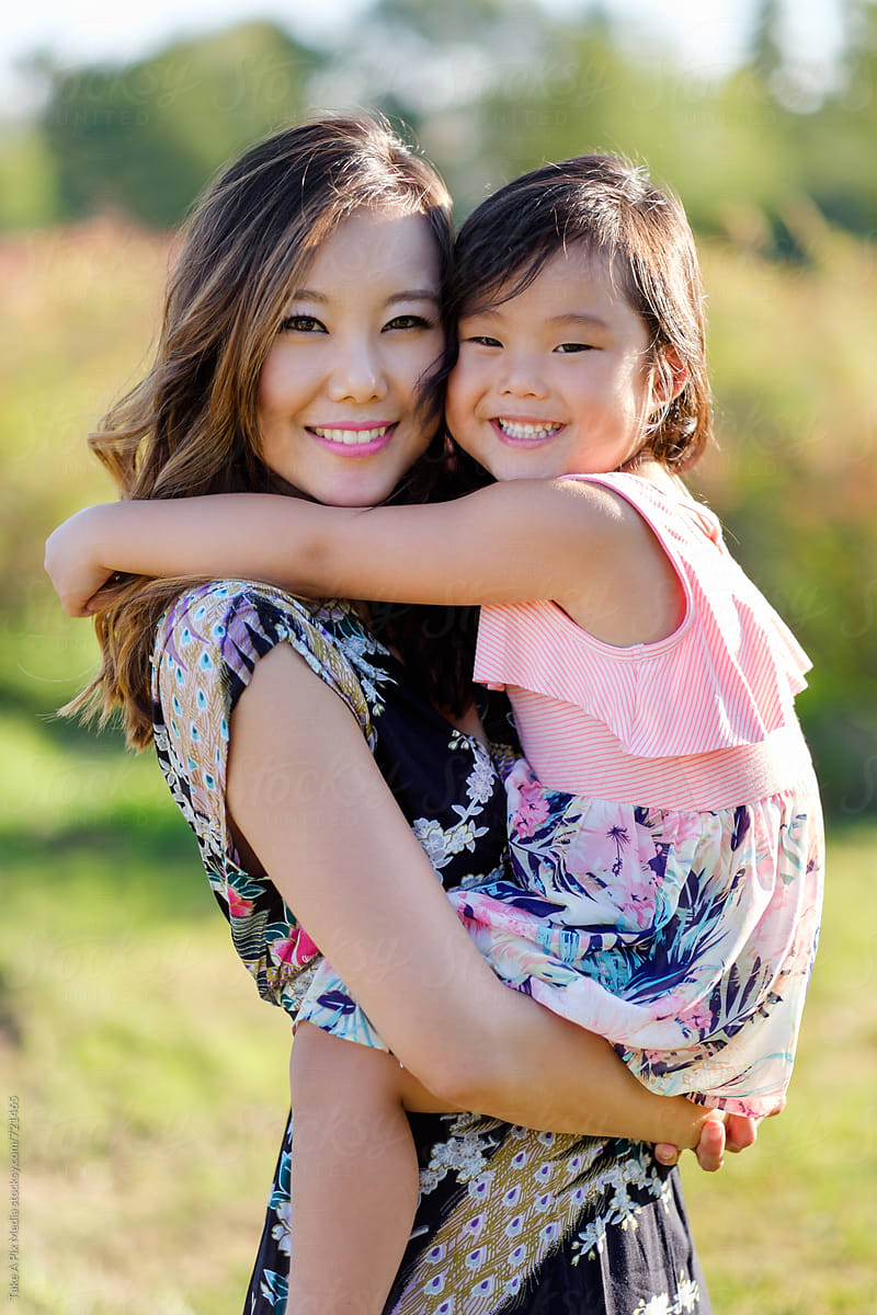 Happy Asian Mother And Daughter In A Park By Stocksy Contributor