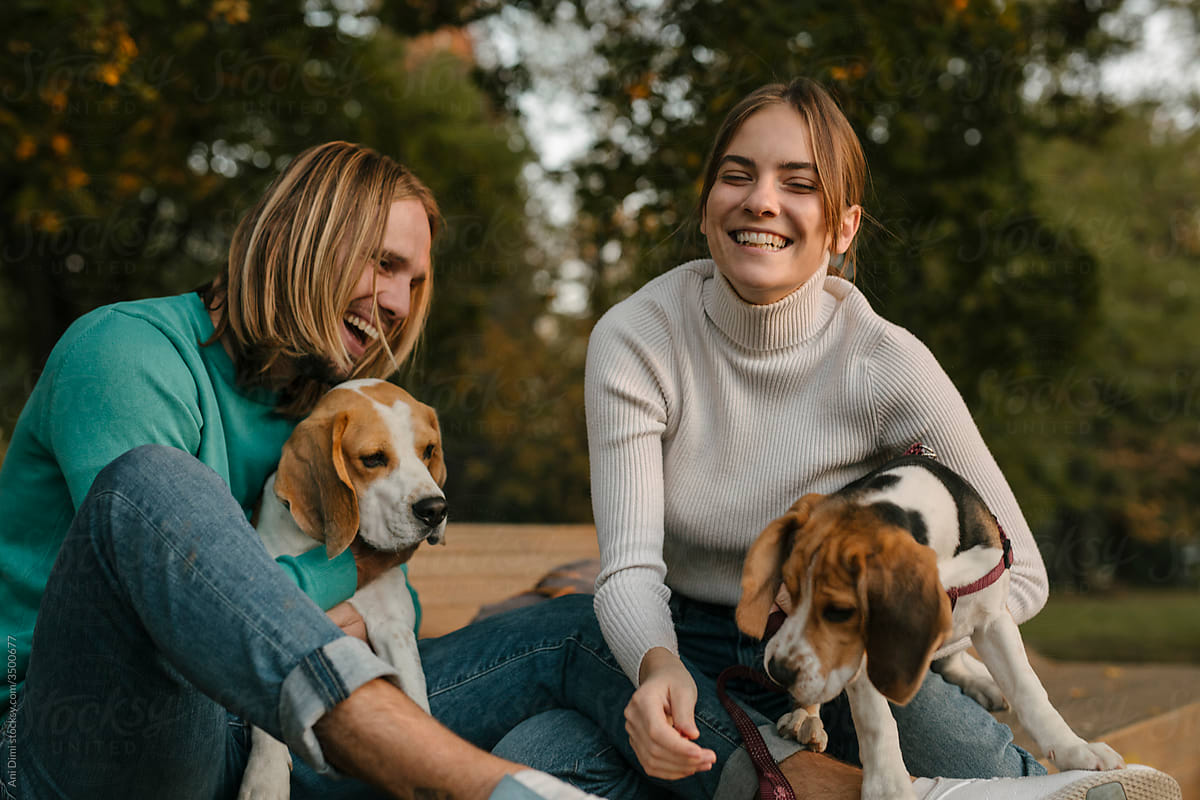 Young couple with their beagle dogs