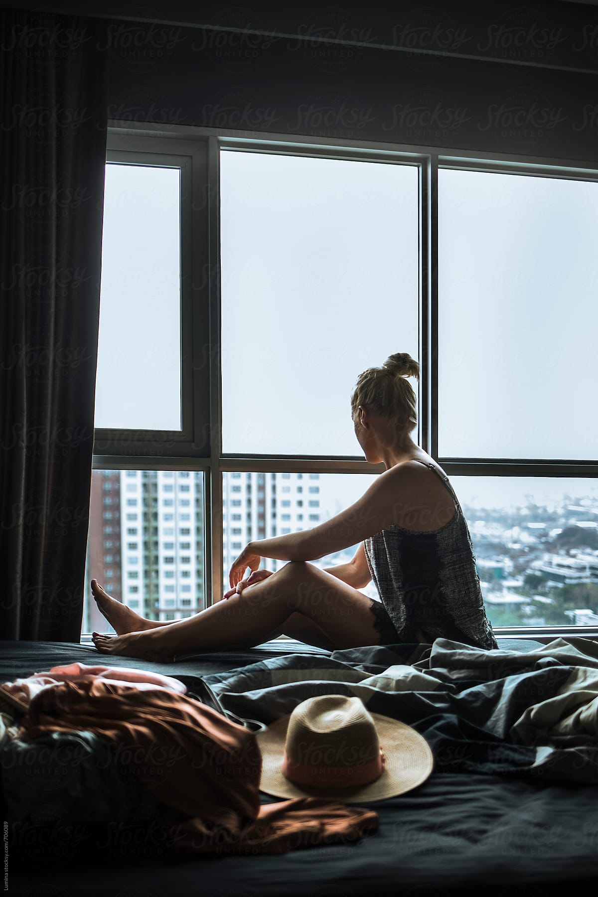 Woman Sitting in a Hotel Room